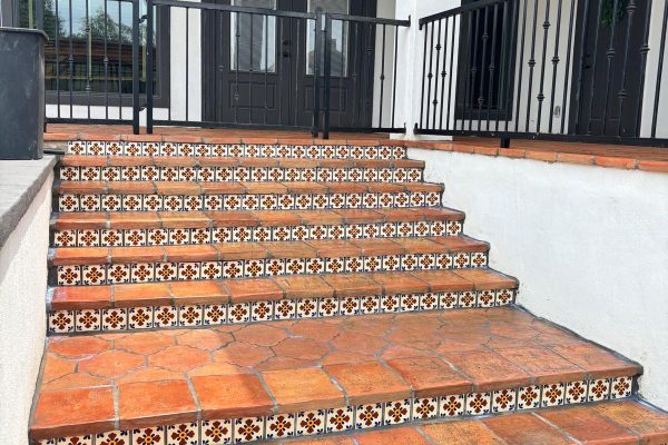 Terracotta tile step bullnose with Talavera risers installed on pack patio