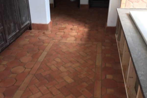 Octagon and dot Saltillo natural, 3X6" Saltillo natural rug installed in a herringbone pattern for bathroom.